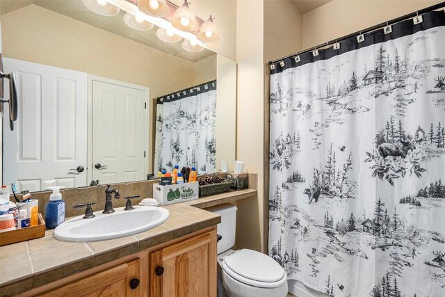 104 Saddle Horn Ct, Granby, CO 80446 - bathroom featuring toilet, a shower with curtain, vanity, and a chandelier