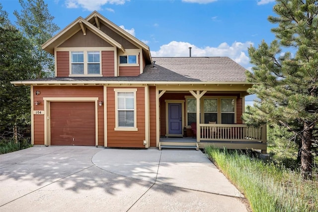 104 Saddle Horn Ct, Granby, CO 80446 - view of front of house with concrete driveway, a garage, a shingled roof, and covered porch