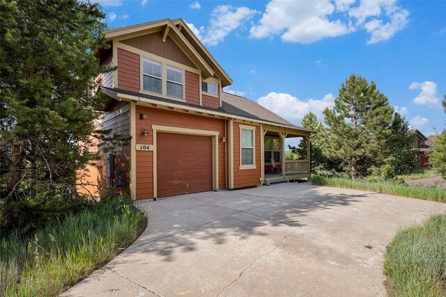 104 Saddle Horn Ct, Granby, CO 80446 - view of front of home with an attached garage, driveway, and covered porch