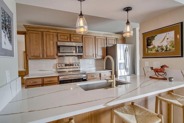 188 E Ln Bonte St Unit 327, Dillon, CO 80435 - kitchen with appliances with stainless steel finishes, decorative backsplash, light stone counters, and hanging light fixtures