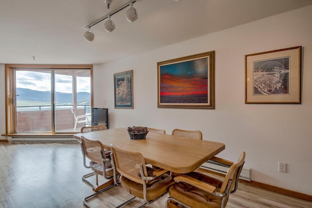 188 E Ln Bonte St Unit 327, Dillon, CO 80435 - dining area with light wood finished floors, baseboard heating, and rail lighting
