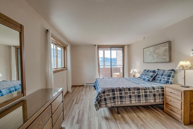 188 E Ln Bonte St Unit 327, Dillon, CO 80435 - bedroom with baseboard heating, multiple windows, and light wood-type flooring