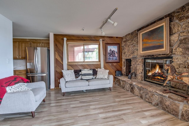 188 E Ln Bonte St Unit 327, Dillon, CO 80435 - living area featuring light wood finished floors, rail lighting, and a fireplace