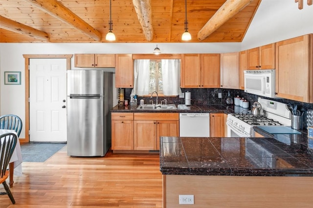 kitchen featuring wood ceiling, tile countertops, beam ceiling, a sink, and white appliances