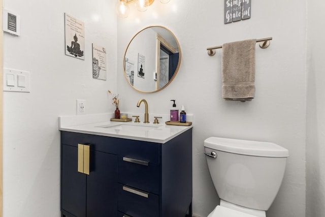 bathroom with toilet and vanity