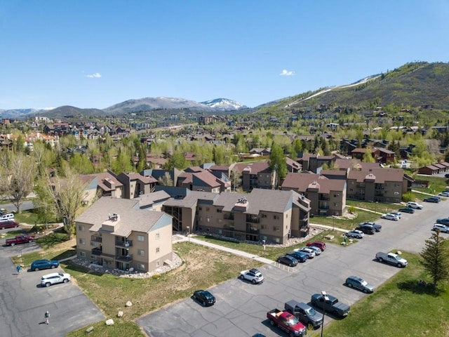 aerial overview of property's location featuring a mountainous background and nearby suburban area