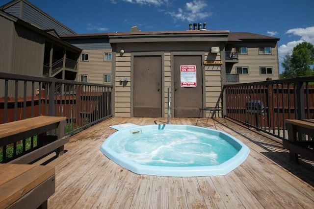 view of pool featuring an outdoor hot tub and a deck