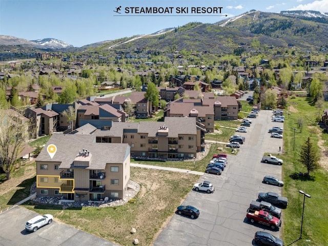 aerial view of residential area featuring a mountainous background