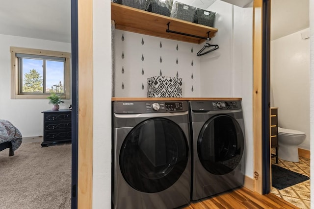 laundry area with washer and dryer and baseboards