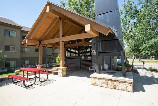 surrounding community with a patio area, a gazebo, and a fire pit
