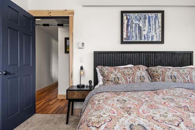 bedroom featuring carpet flooring and baseboards