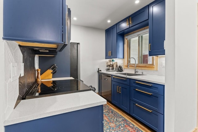 kitchen with a sink, blue cabinets, stainless steel dishwasher, recessed lighting, and light wood-style flooring
