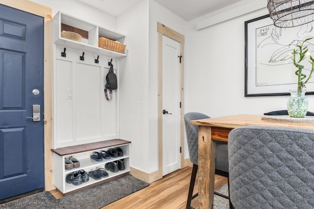 mudroom featuring wood finished floors and baseboards