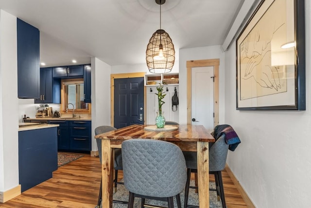 dining area with wood finished floors and baseboards