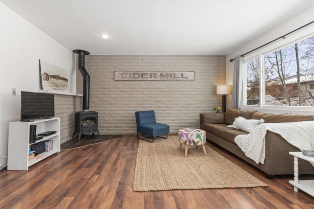 3 Cedar Ct Unit 3, Steamboat Springs, CO 80487 - living room with a wood stove, wood finished floors, brick wall, and recessed lighting