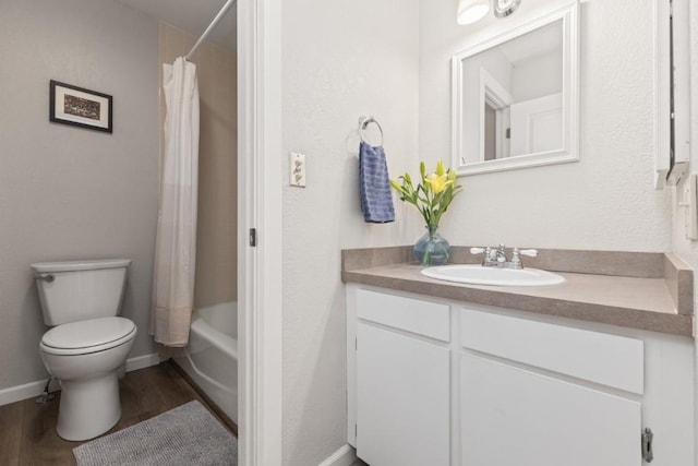 3 Cedar Ct Unit 3, Steamboat Springs, CO 80487 - bathroom with vanity, toilet, wood finished floors, shower / bath combo with shower curtain, and baseboards