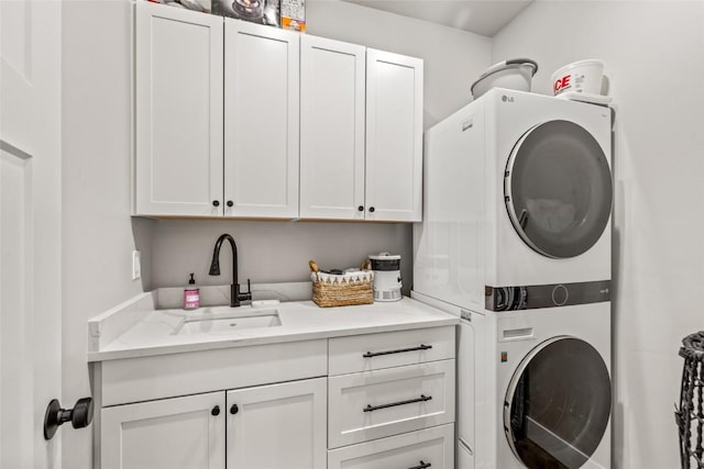 23430 Postrider Trl, Oak Creek, CO 80467 - laundry room featuring stacked washer and clothes dryer and cabinet space