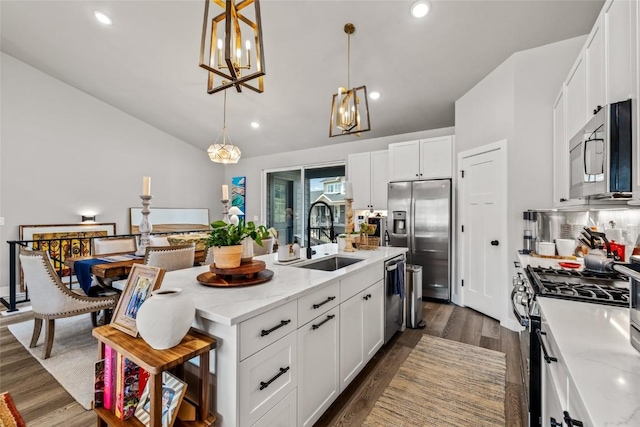 23430 Postrider Trl, Oak Creek, CO 80467 - kitchen with appliances with stainless steel finishes, a sink, a chandelier, lofted ceiling, and a kitchen island with sink