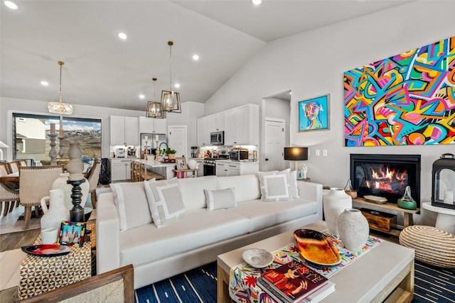 23430 Postrider Trl, Oak Creek, CO 80467 - living area featuring vaulted ceiling, recessed lighting, wood finished floors, and a glass covered fireplace