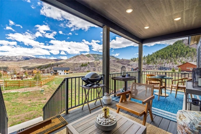 23430 Postrider Trl, Oak Creek, CO 80467 - wooden deck with a mountain view and a lawn