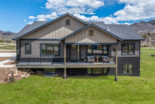 23430 Postrider Trl, Oak Creek, CO 80467 - back of house with roof with shingles, a yard, and a deck with mountain view
