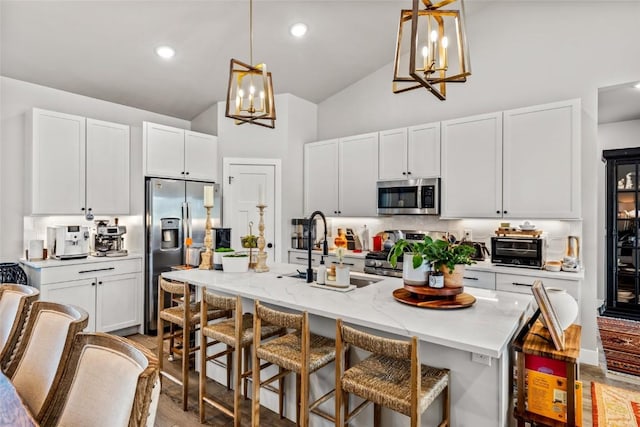 23430 Postrider Trl, Oak Creek, CO 80467 - kitchen featuring stainless steel appliances, a chandelier, a sink, high vaulted ceiling, and hanging light fixtures