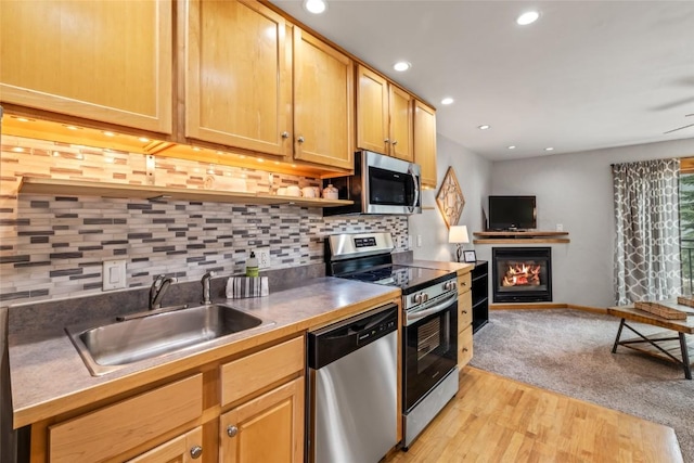 2883 Burgess Creek Rd Unit 202, Steamboat Springs, CO 80487 - kitchen with stainless steel appliances, a sink, recessed lighting, open floor plan, and decorative backsplash
