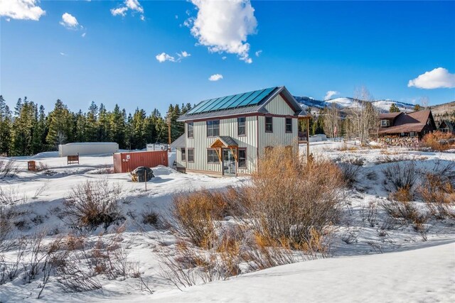 25640 6th Ave, Hahns Peak, CO 80428 - snow covered rear of property with board and batten siding and a balcony
