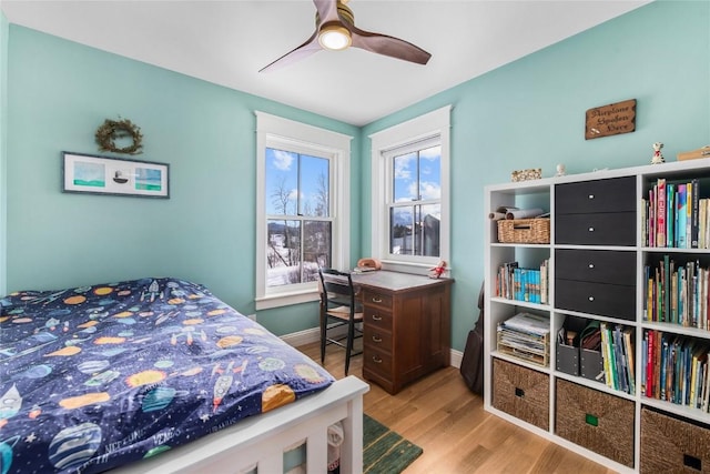 25640 6th Ave, Hahns Peak, CO 80428 - bedroom with baseboards, a ceiling fan, wood finished floors, and multiple windows