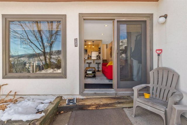 property entrance with stucco siding