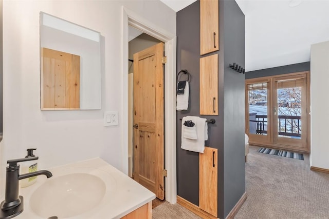 bathroom featuring baseboards and vanity