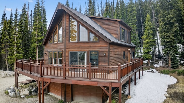 441 Kimmes Ln, Breckenridge, CO 80424 - rear view of house with a garage, a wooden deck, a forest view, and roof with shingles
