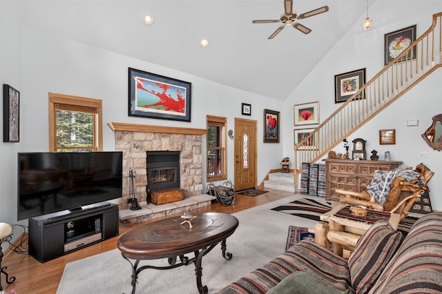 441 Kimmes Ln, Breckenridge, CO 80424 - living room with high vaulted ceiling, stairs, a ceiling fan, wood finished floors, and a stone fireplace