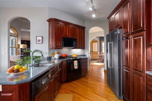 43855 Old Elk Trl, Steamboat Springs, CO 80487 - kitchen featuring black appliances, dark brown cabinets, arched walkways, and a sink