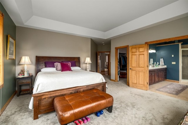 43855 Old Elk Trl, Steamboat Springs, CO 80487 - bedroom with a raised ceiling, a walk in closet, light carpet, and baseboards