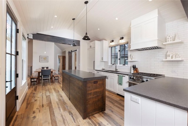 300 E Washington Ave, Breckenridge, CO 80424 - kitchen featuring dark countertops, open shelves, lofted ceiling, high end range, and light wood-type flooring