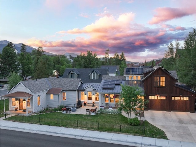 300 E Washington Ave, Breckenridge, CO 80424 - view of front of home featuring concrete driveway, solar panels, a garage, a standing seam roof, and a metal roof