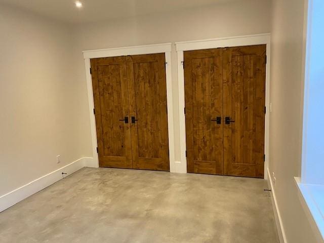 300 E Washington Ave, Breckenridge, CO 80424 - unfurnished bedroom featuring concrete floors and two closets