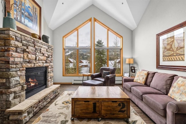 23110 US Highway 6 Unit 5044, Keystone, CO 80435 - living area with vaulted ceiling, a fireplace, wood finished floors, a baseboard heating unit, and baseboards