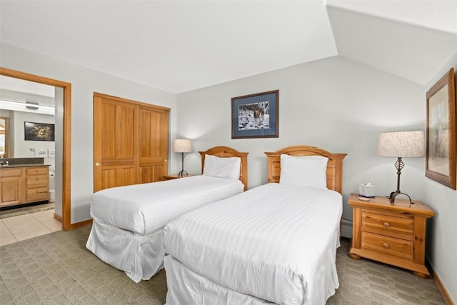 23110 US Highway 6 Unit 5044, Keystone, CO 80435 - bedroom featuring ensuite bathroom, a closet, lofted ceiling, and light tile patterned floors