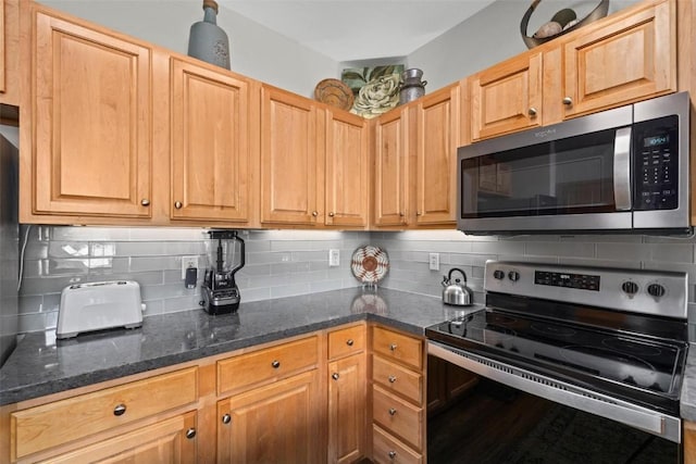 23110 US Highway 6 Unit 5044, Keystone, CO 80435 - kitchen with appliances with stainless steel finishes, backsplash, and dark stone counters
