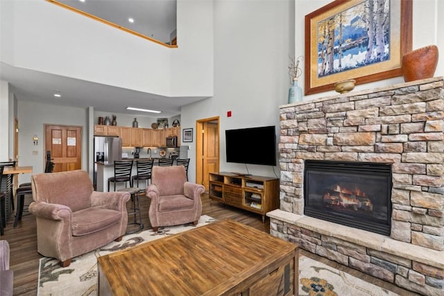 23110 US Highway 6 Unit 5044, Keystone, CO 80435 - living room with wood finished floors, a fireplace, and a towering ceiling
