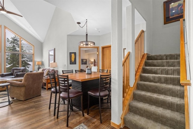 23110 US Highway 6 Unit 5044, Keystone, CO 80435 - dining room with wood finished floors, stairs, a chandelier, high vaulted ceiling, and ceiling fan