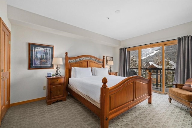 23110 US Highway 6 Unit 5044, Keystone, CO 80435 - bedroom featuring access to exterior, baseboards, and light carpet