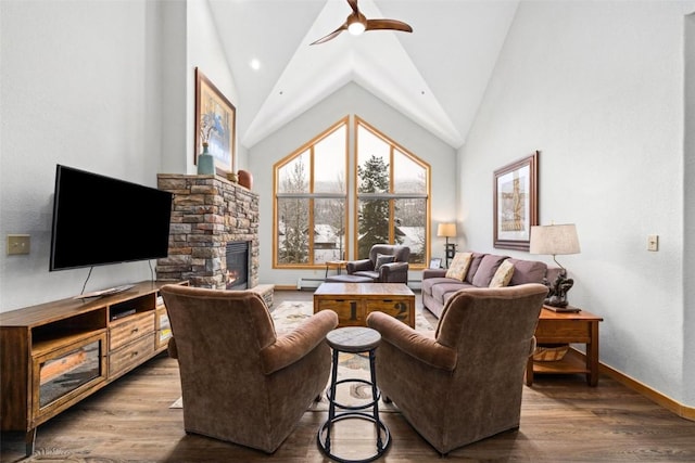 23110 US Highway 6 Unit 5044, Keystone, CO 80435 - living area featuring a ceiling fan, a fireplace, baseboards, wood finished floors, and high vaulted ceiling