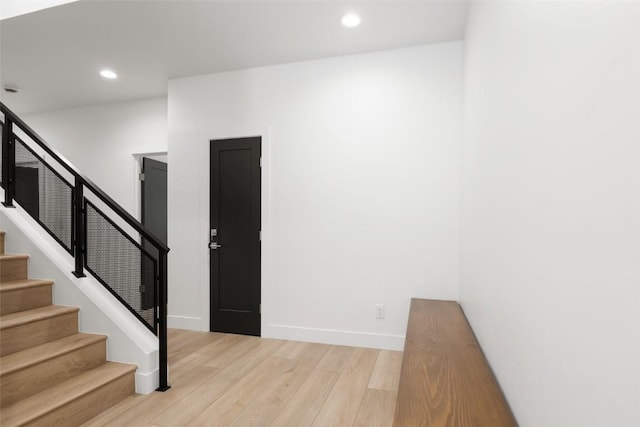 stairs with hardwood / wood-style flooring