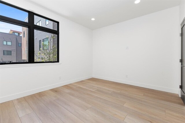 spare room with a healthy amount of sunlight and light wood-type flooring