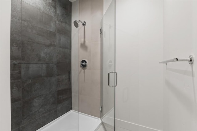 bathroom with a shower with door