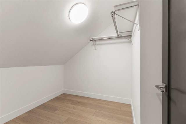 spacious closet featuring vaulted ceiling and light hardwood / wood-style floors