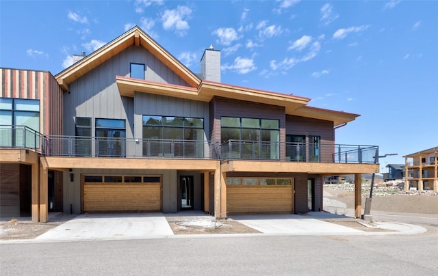 contemporary home featuring a garage and a balcony